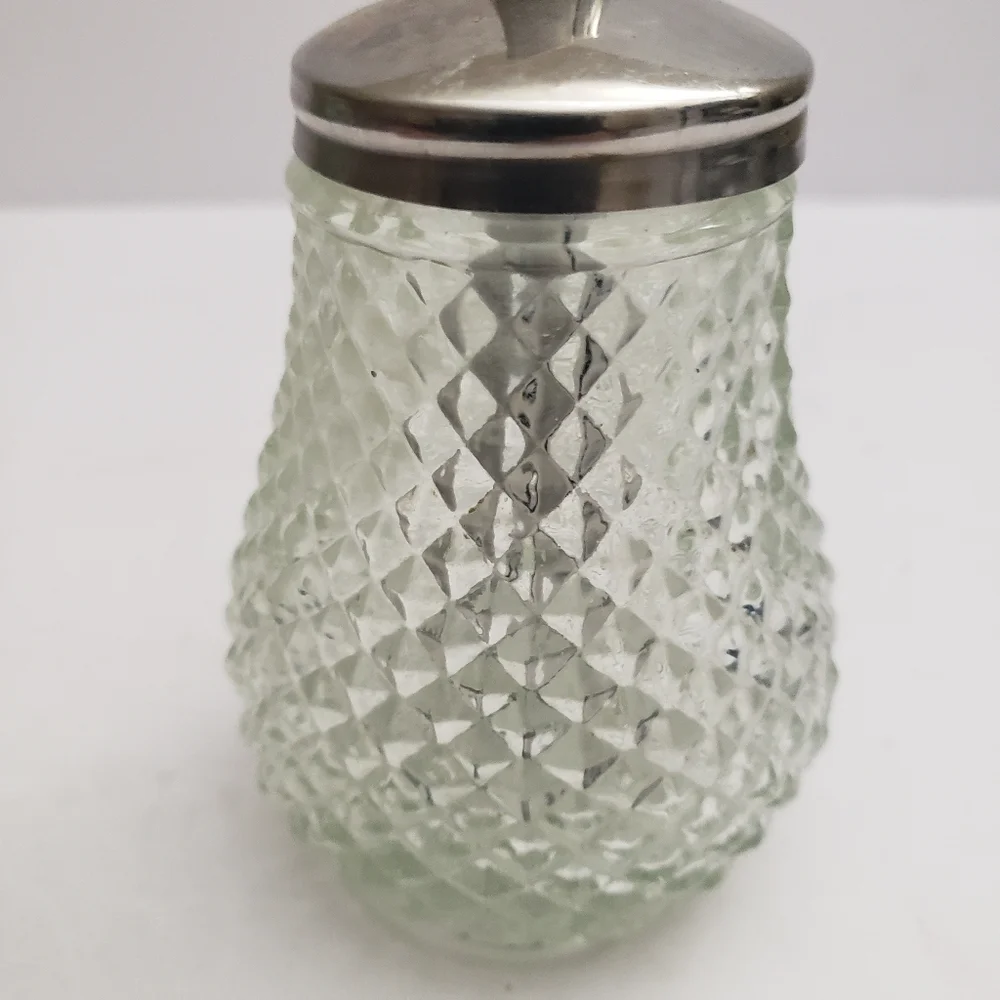 Glass sugar dispenser with a metal lid and spout. 206